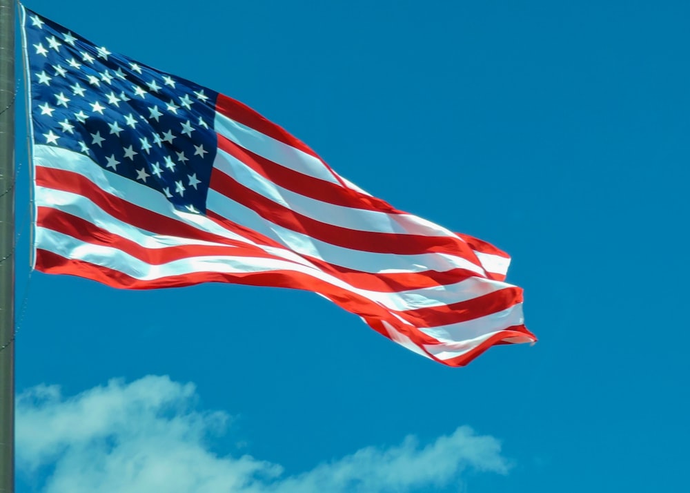 a large american flag flying in the sky