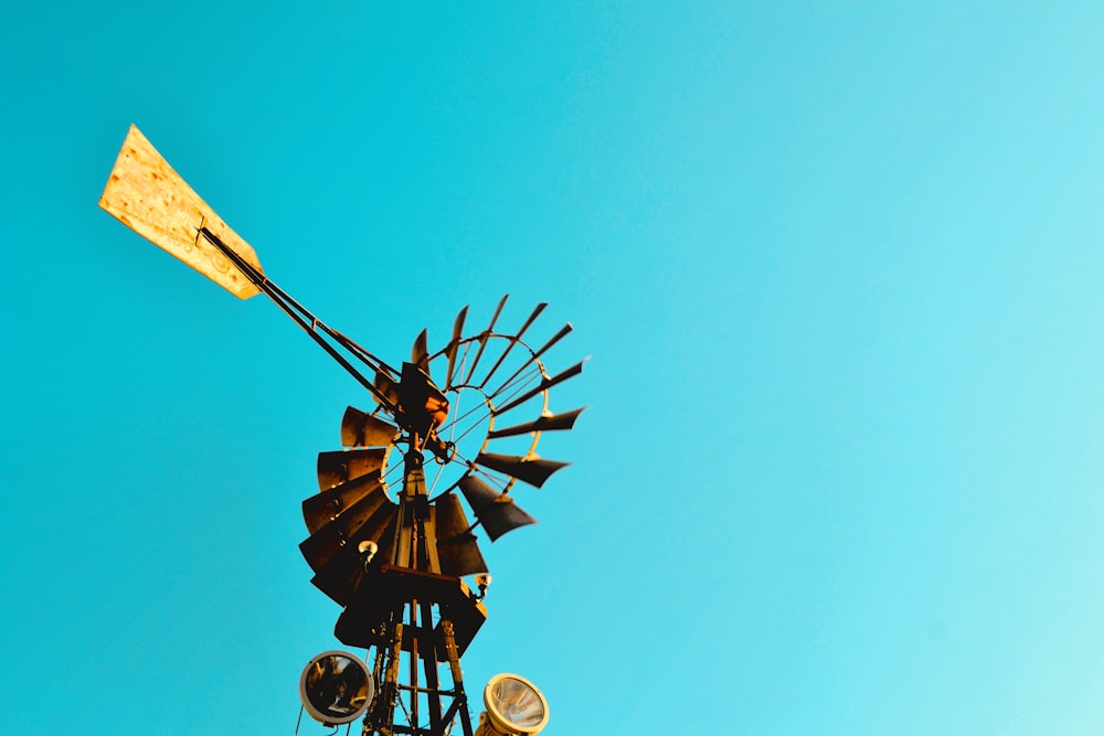 a windmill on top of a building with a blue sky in the background