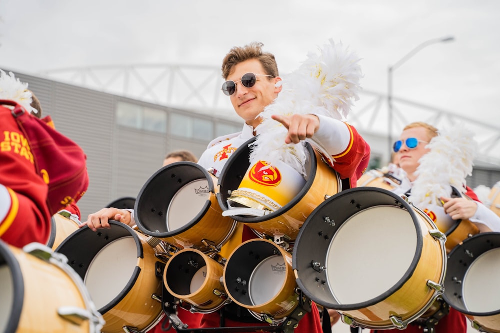 a group of drummers in red and yellow outfits