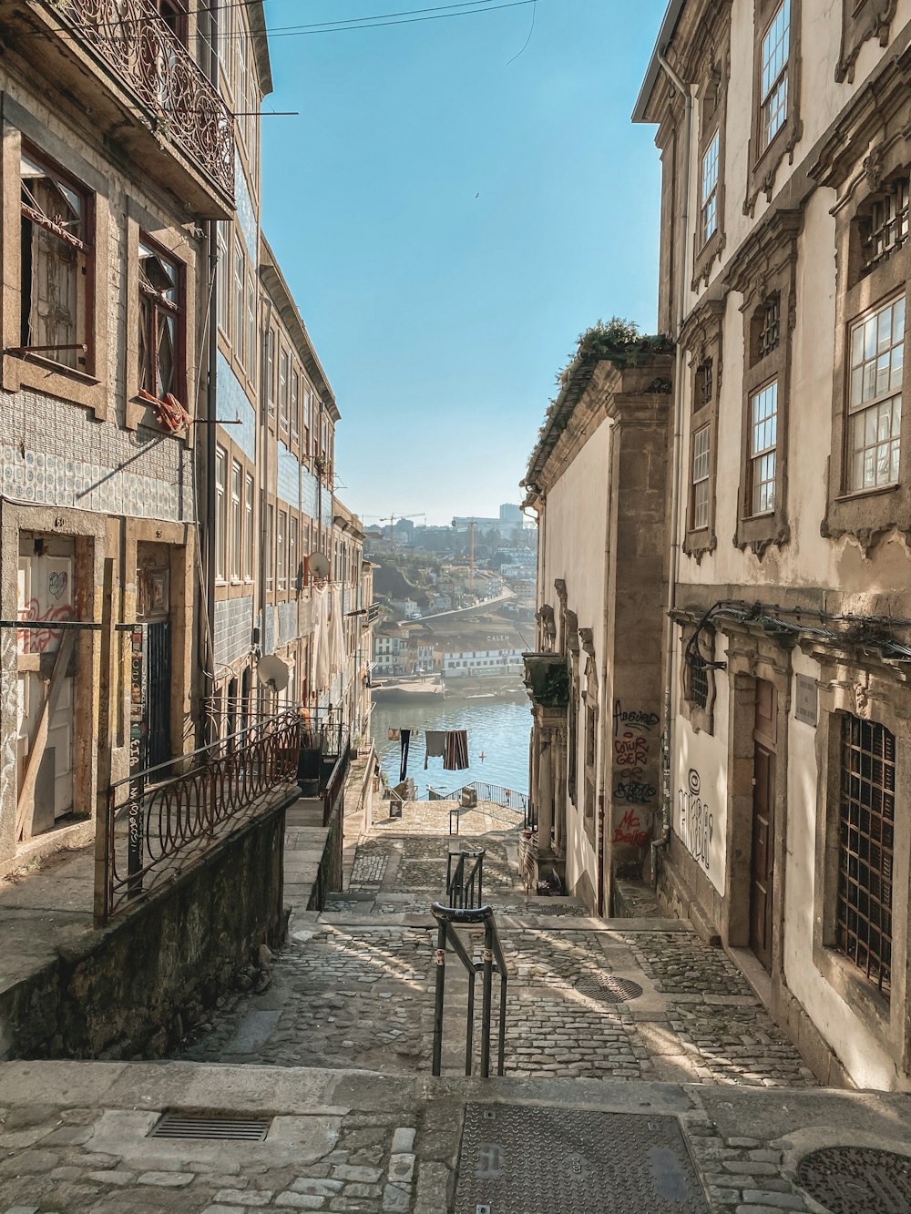 a cobblestone street leading to a body of water