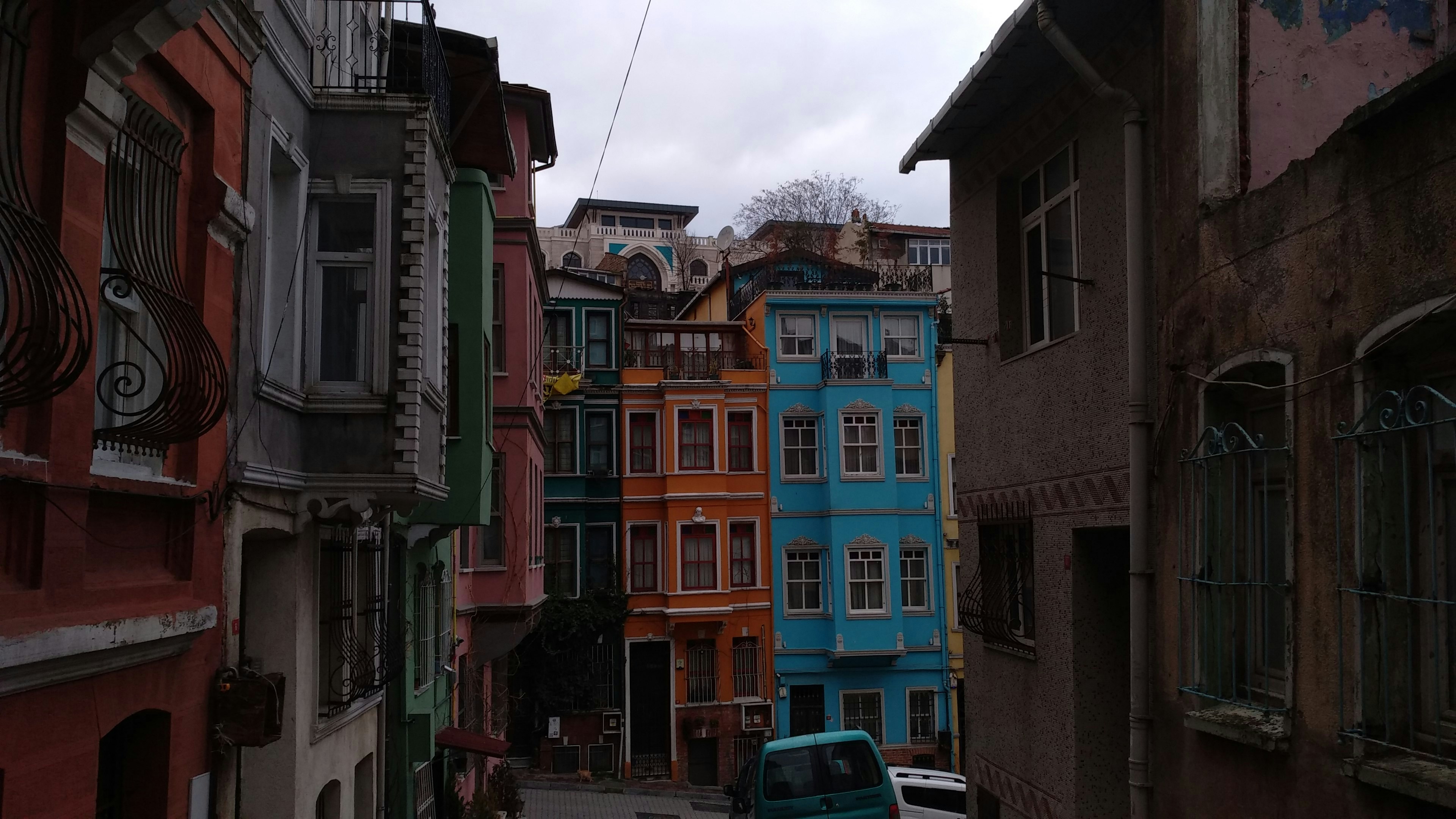 a car is parked on a narrow street