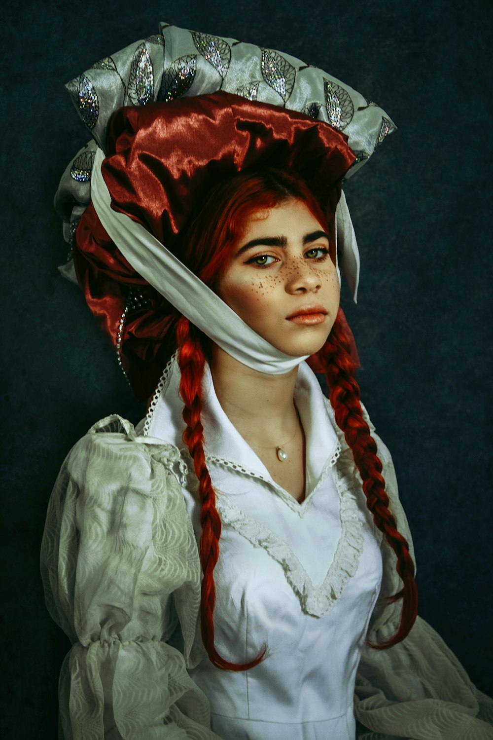 a woman with red hair wearing a white dress and a red hat