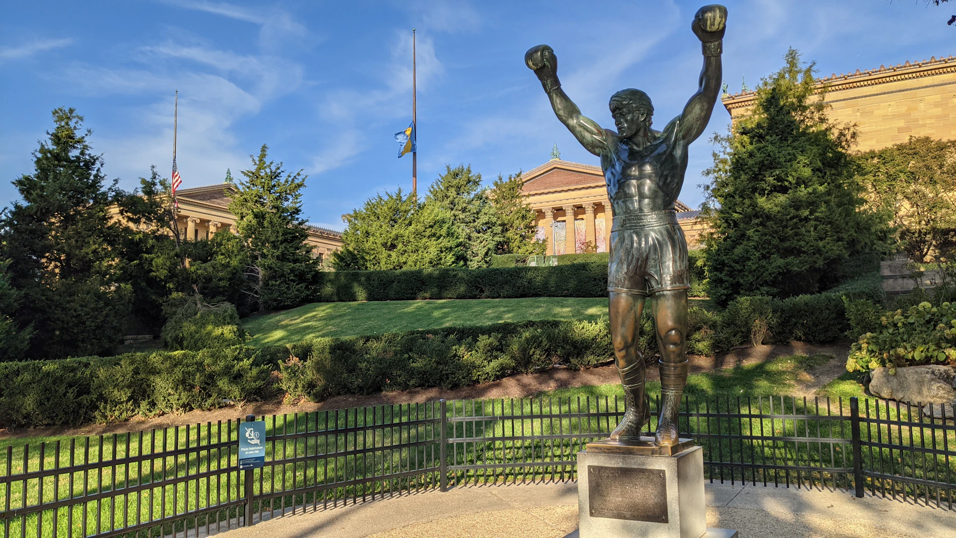 a statue of a man with his arms in the air