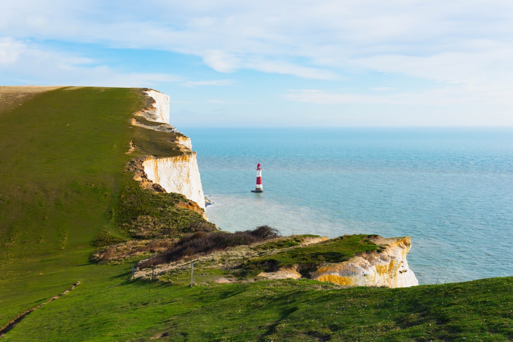 a lighthouse on a cliff overlooking the ocean