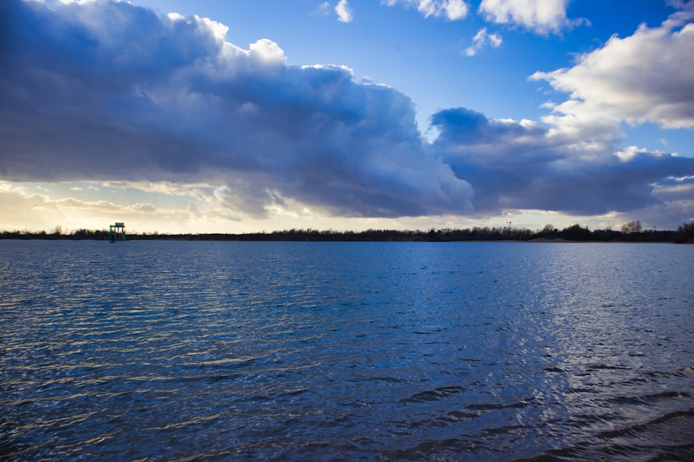 a large body of water under a cloudy sky