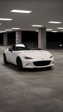 a white sports car parked in a parking garage