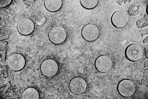Close-up of a bright yellow fiber reinforced plastic manhole cover with a textured surface.