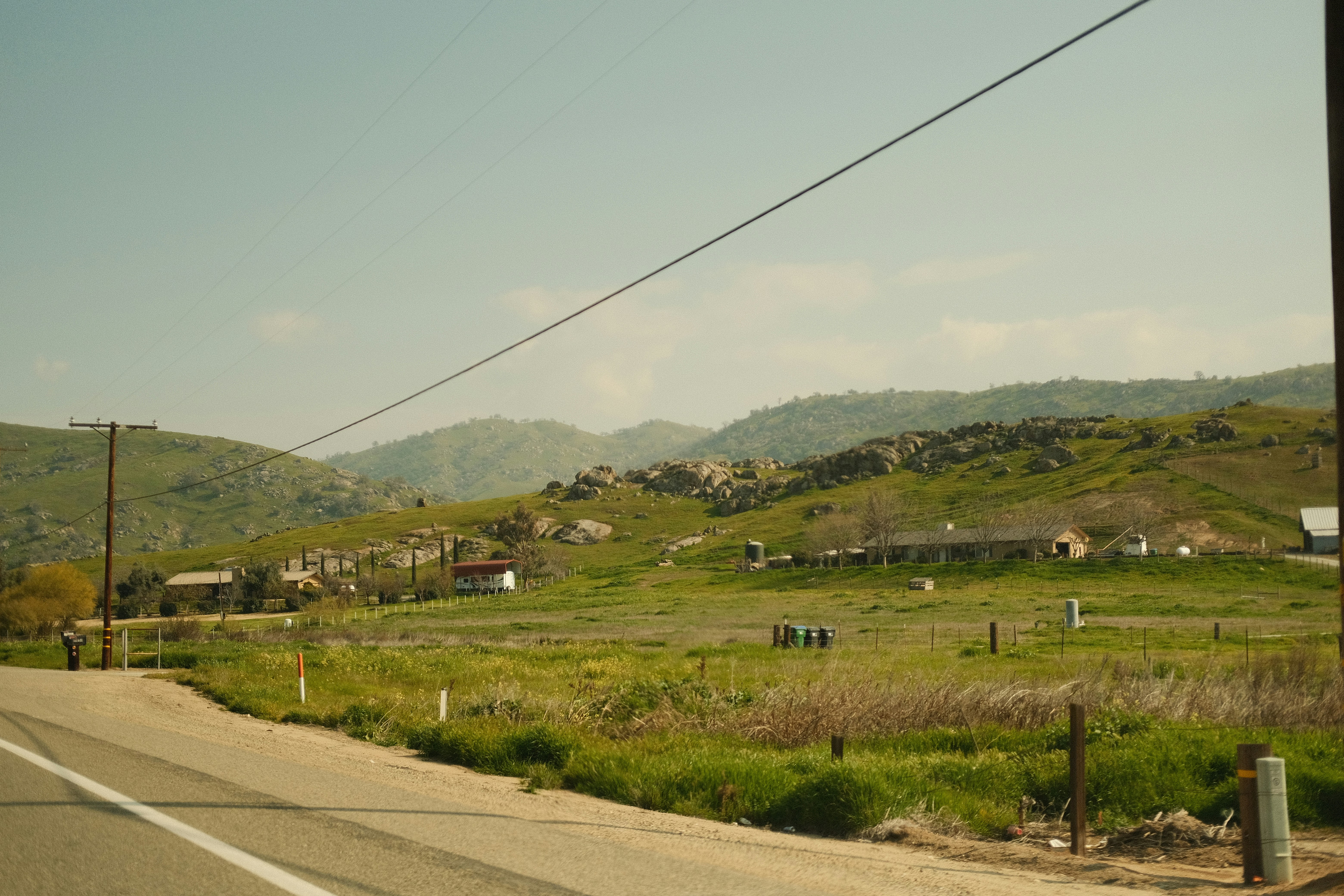 a road with a hill in the background