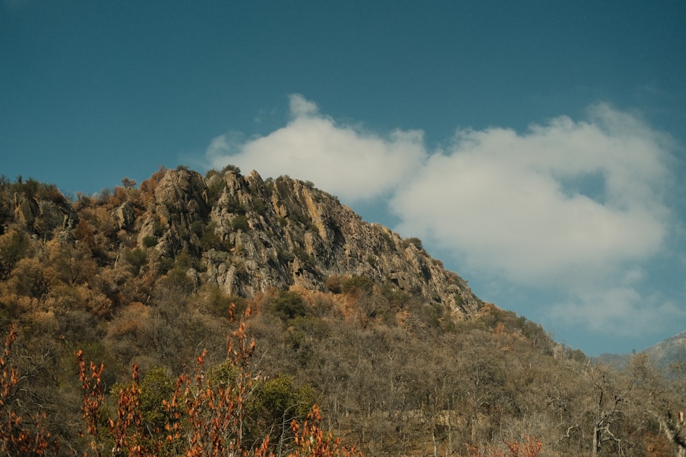 a very tall mountain with a few clouds in the sky