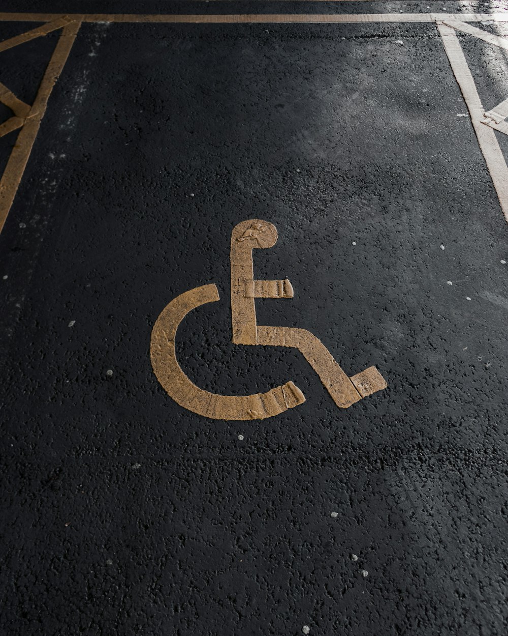 a handicapped sign on the ground in a parking lot