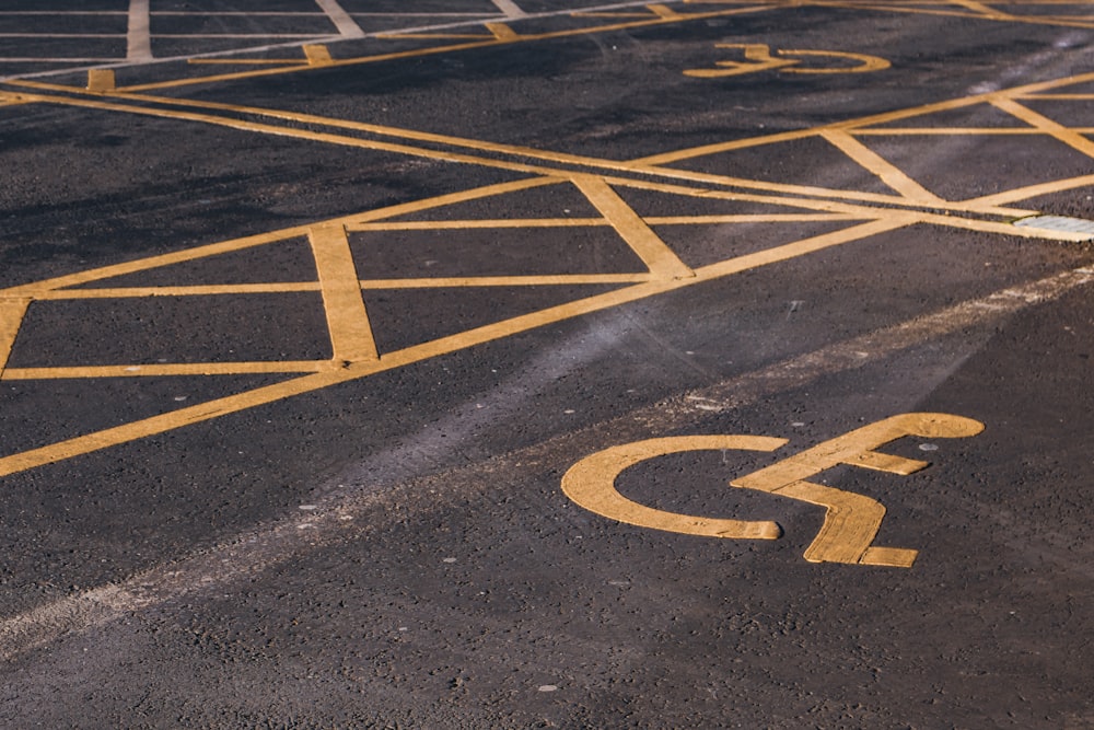 a yellow fire hydrant sitting in the middle of a parking lot