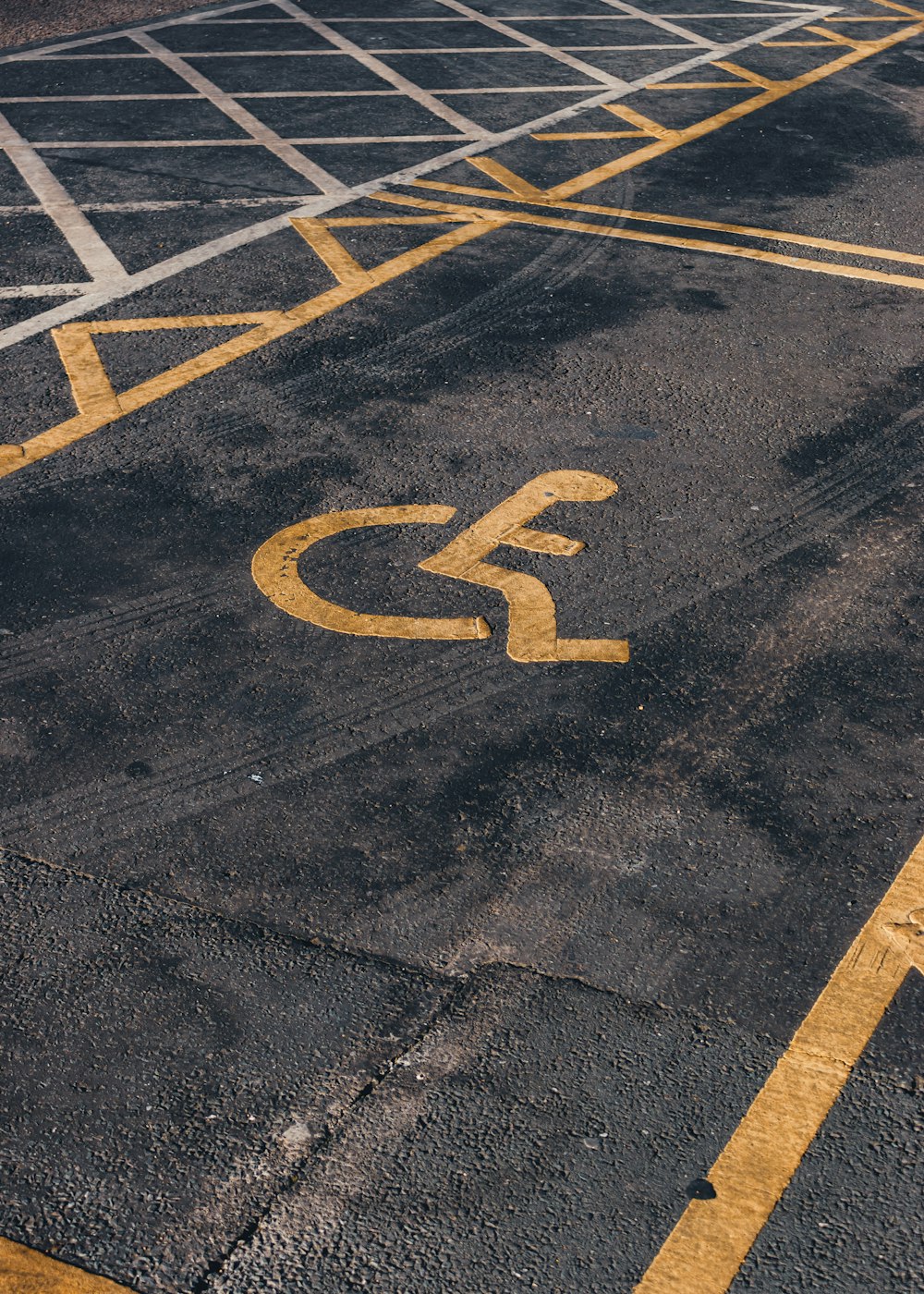 a parking lot with a handicapped sign painted on it