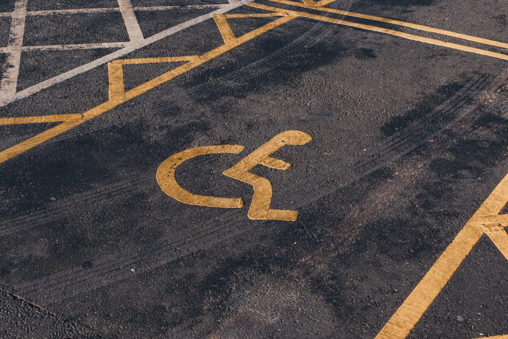 a parking lot with a handicapped sign painted on it