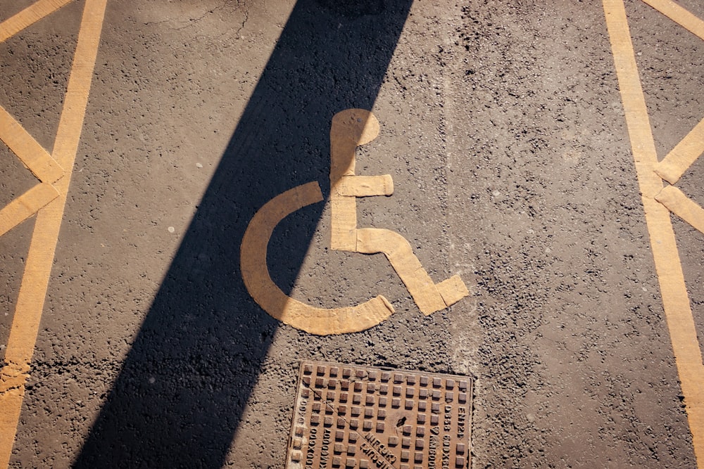the shadow of a person in a wheelchair on the ground