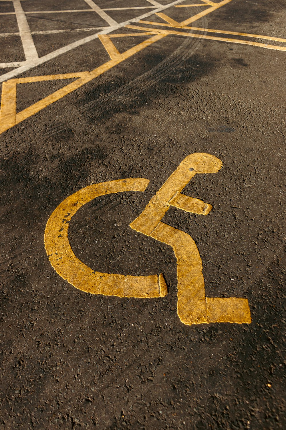 a handicapped sign painted on a parking lot