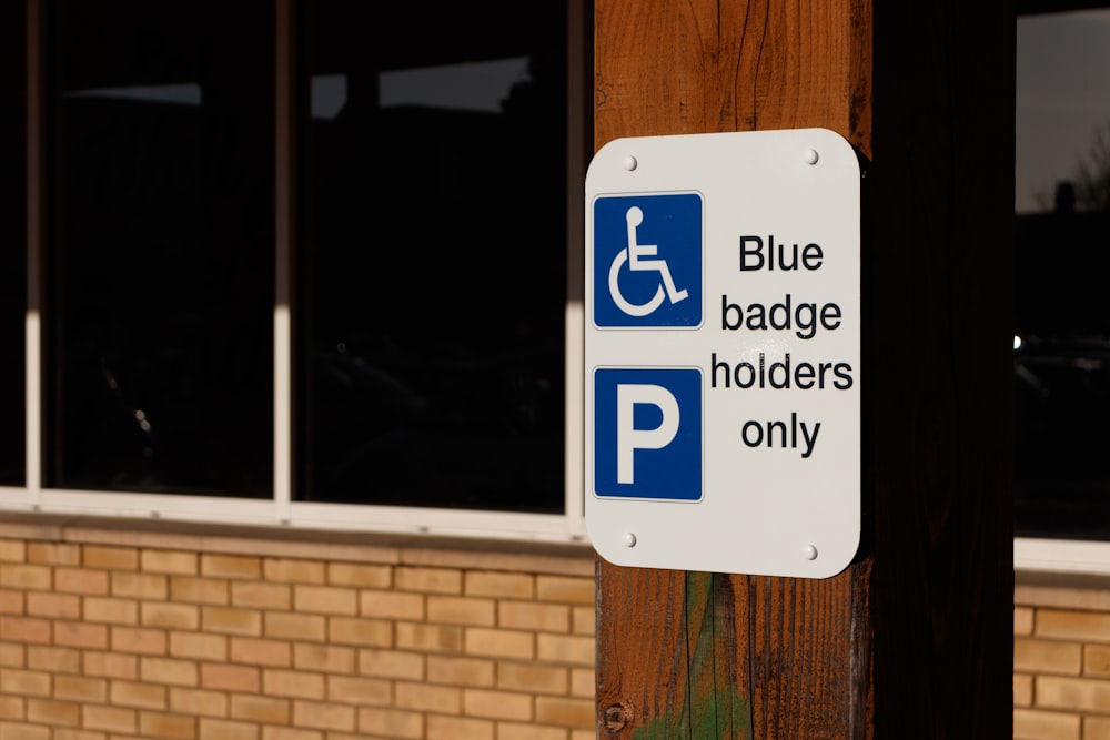 a blue and white sign that says blue baggage holders only