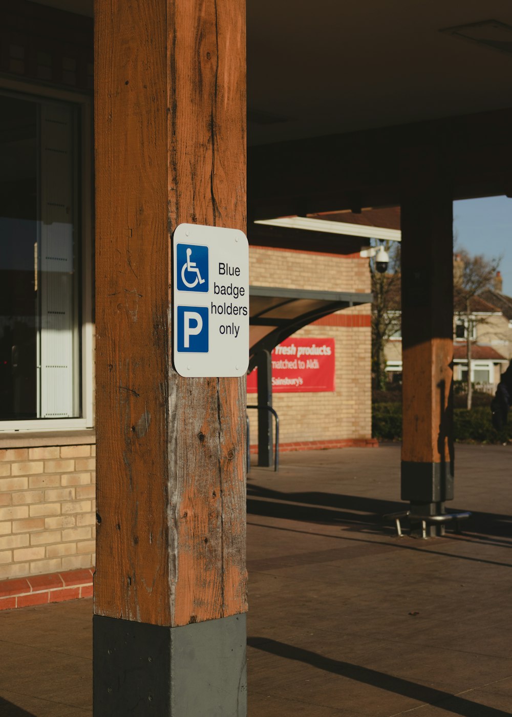 a blue and white sign on a wooden pole