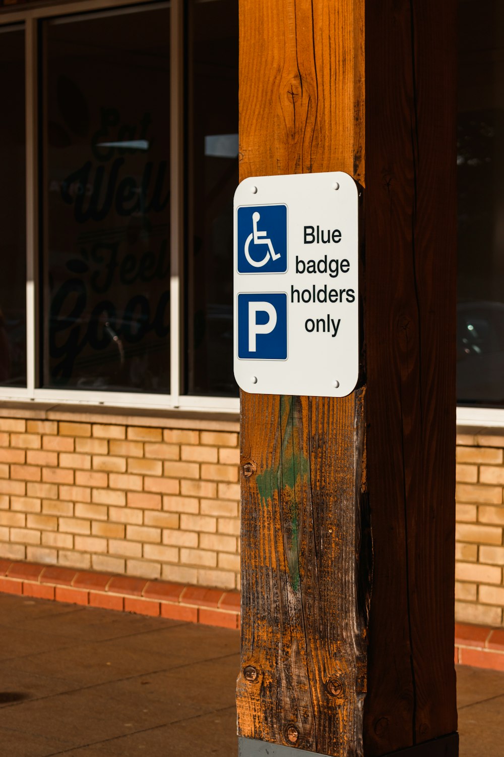 a blue and white sign on a wooden pole