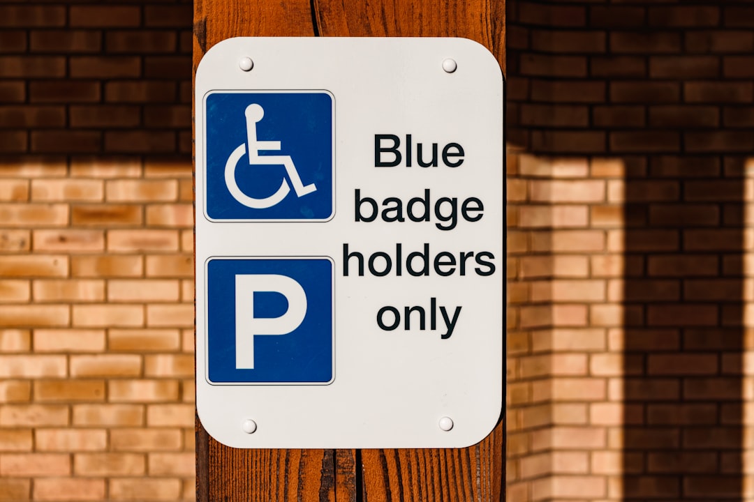 a blue and white sign that says blue badge holders only, Blue badge sign. Disabled parking space sign.
