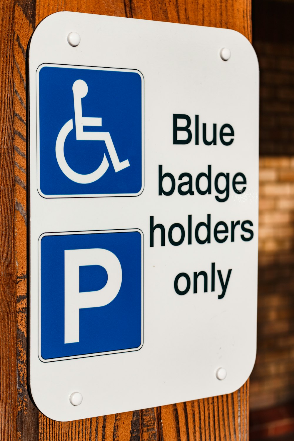 a blue and white sign that says blue badge holders only