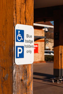 a blue and white sign that says blue badge holders only