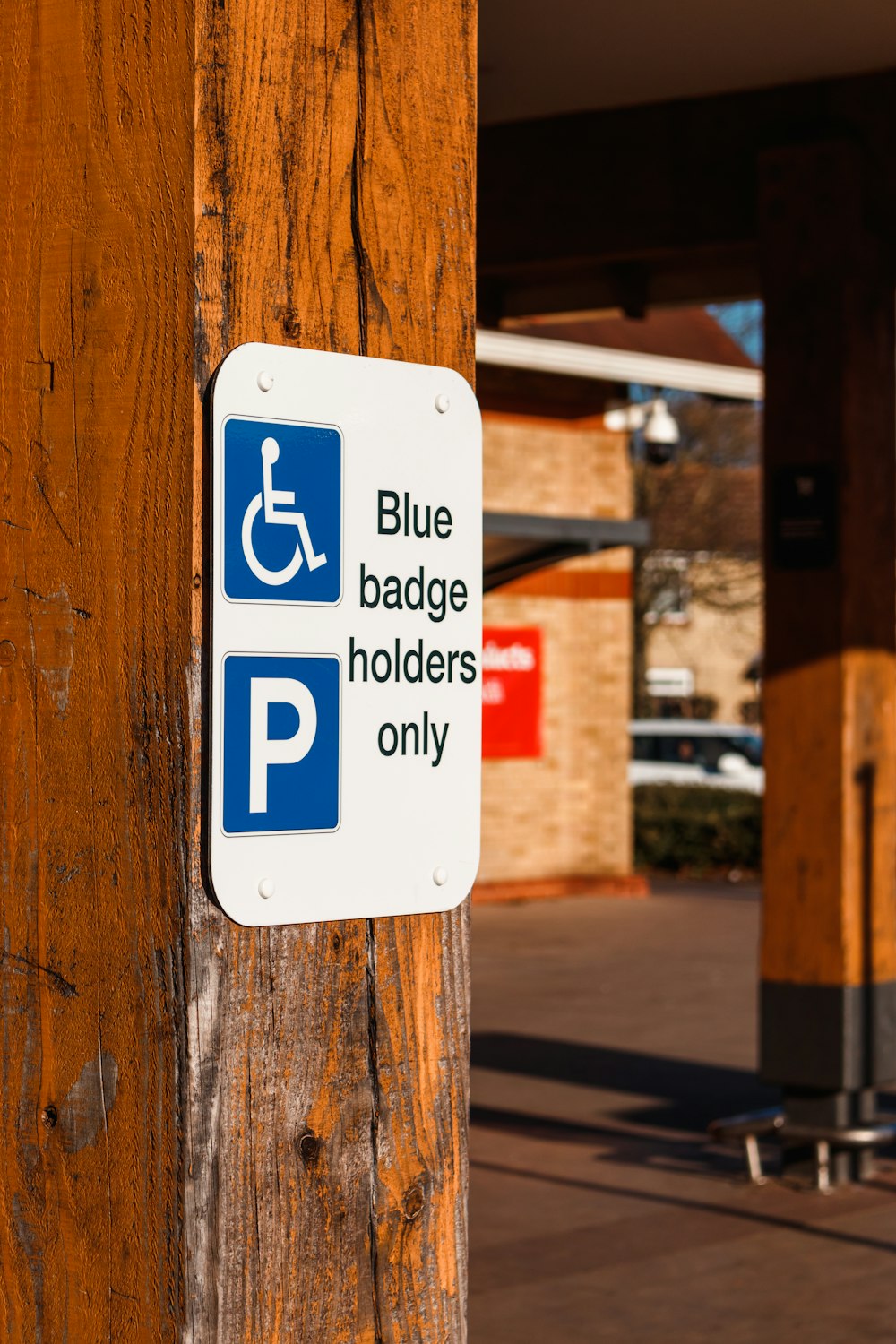 a blue and white sign that says blue badge holders only