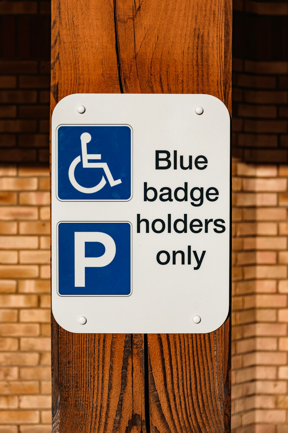 a blue and white sign that says blue badge holders only