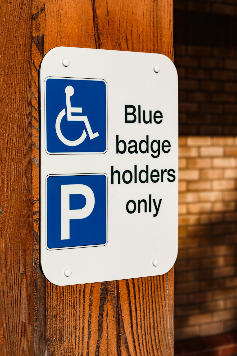 a blue and white sign that says blue badge holders only