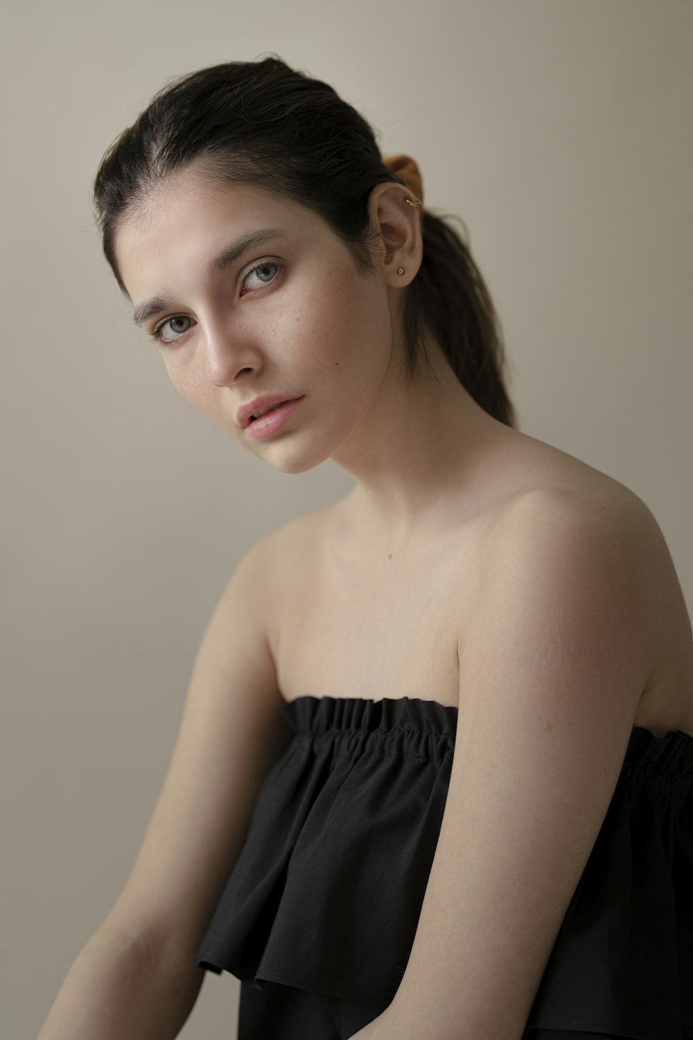 a woman in a black dress is posing for a picture