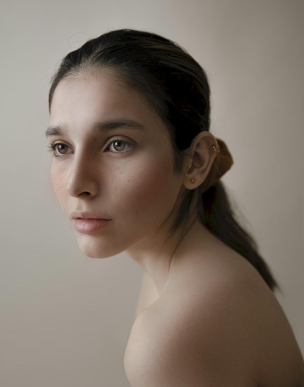 a woman with a ponytail is posing for a picture