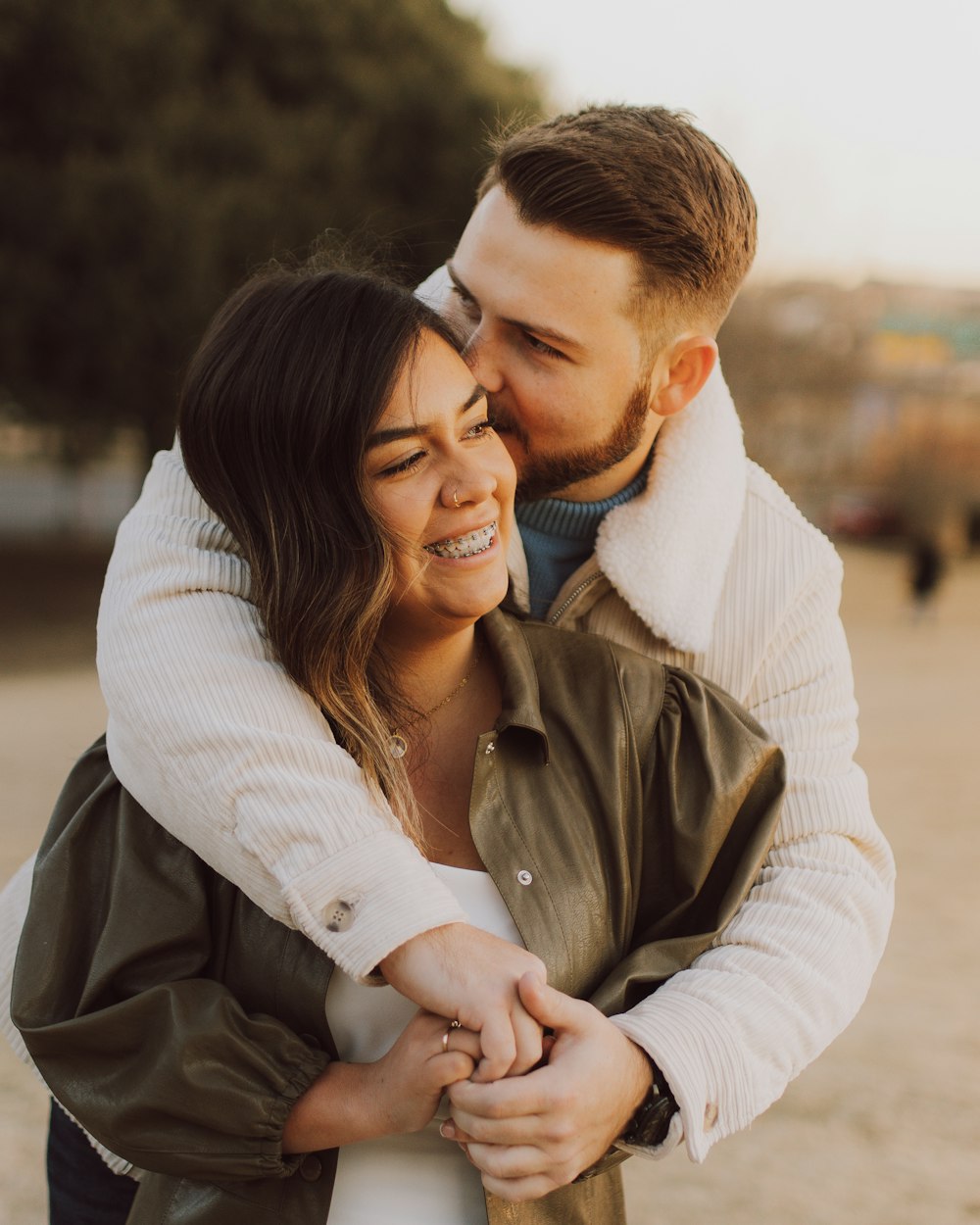 a man holding a woman on the beach