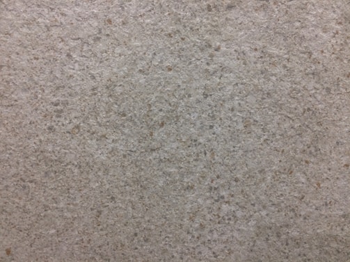 Durable epoxy flooring with a speckled finish in a busy warehouse setting.