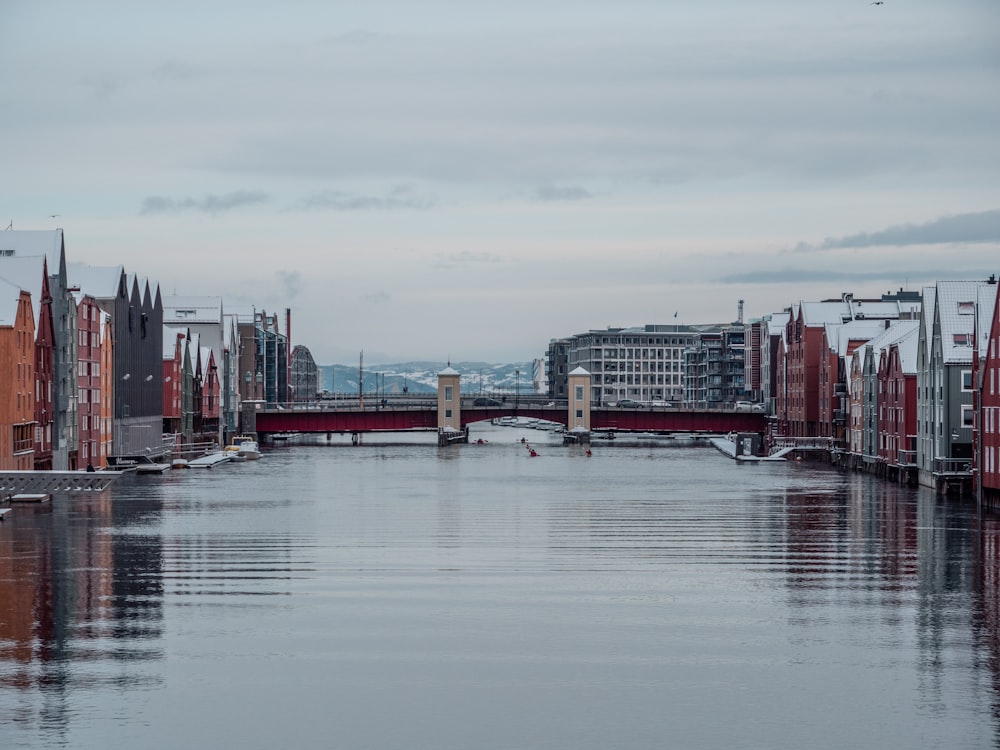 a body of water surrounded by buildings and a bridge