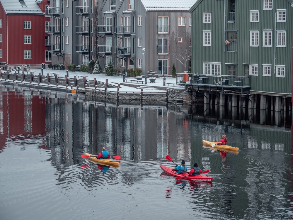 a group of people riding kayaks on top of a body of water