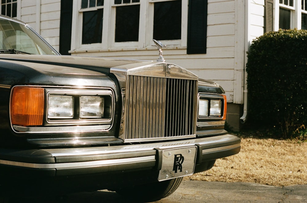 a black car parked in front of a house