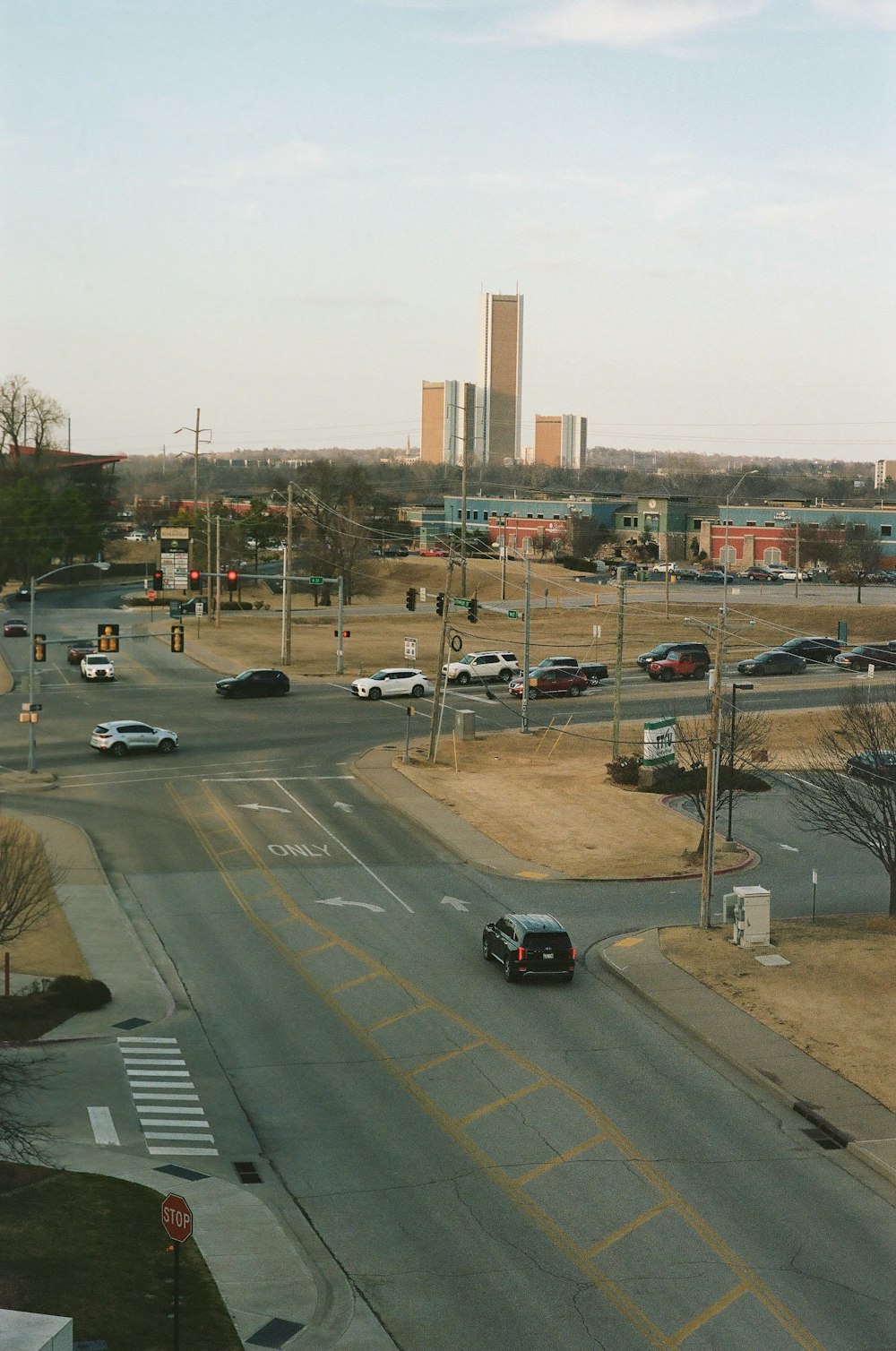 a city street filled with lots of traffic next to tall buildings