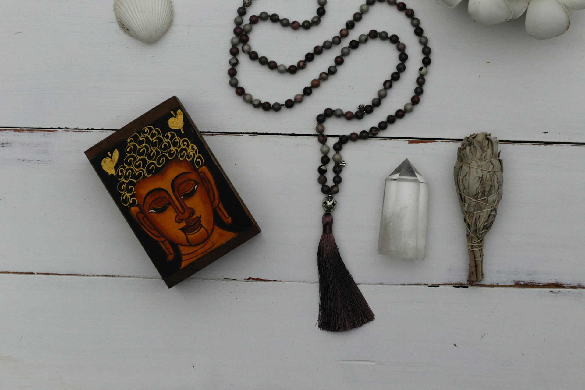 a necklace with a buddha face on it