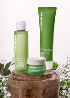 a couple of bottles of green stuff sitting on top of a wooden table