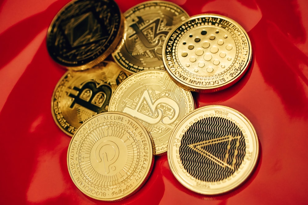 a pile of bitcoins sitting on top of a red table