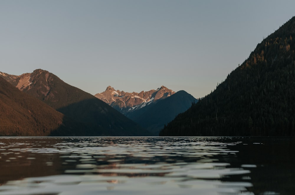 a body of water with mountains in the background