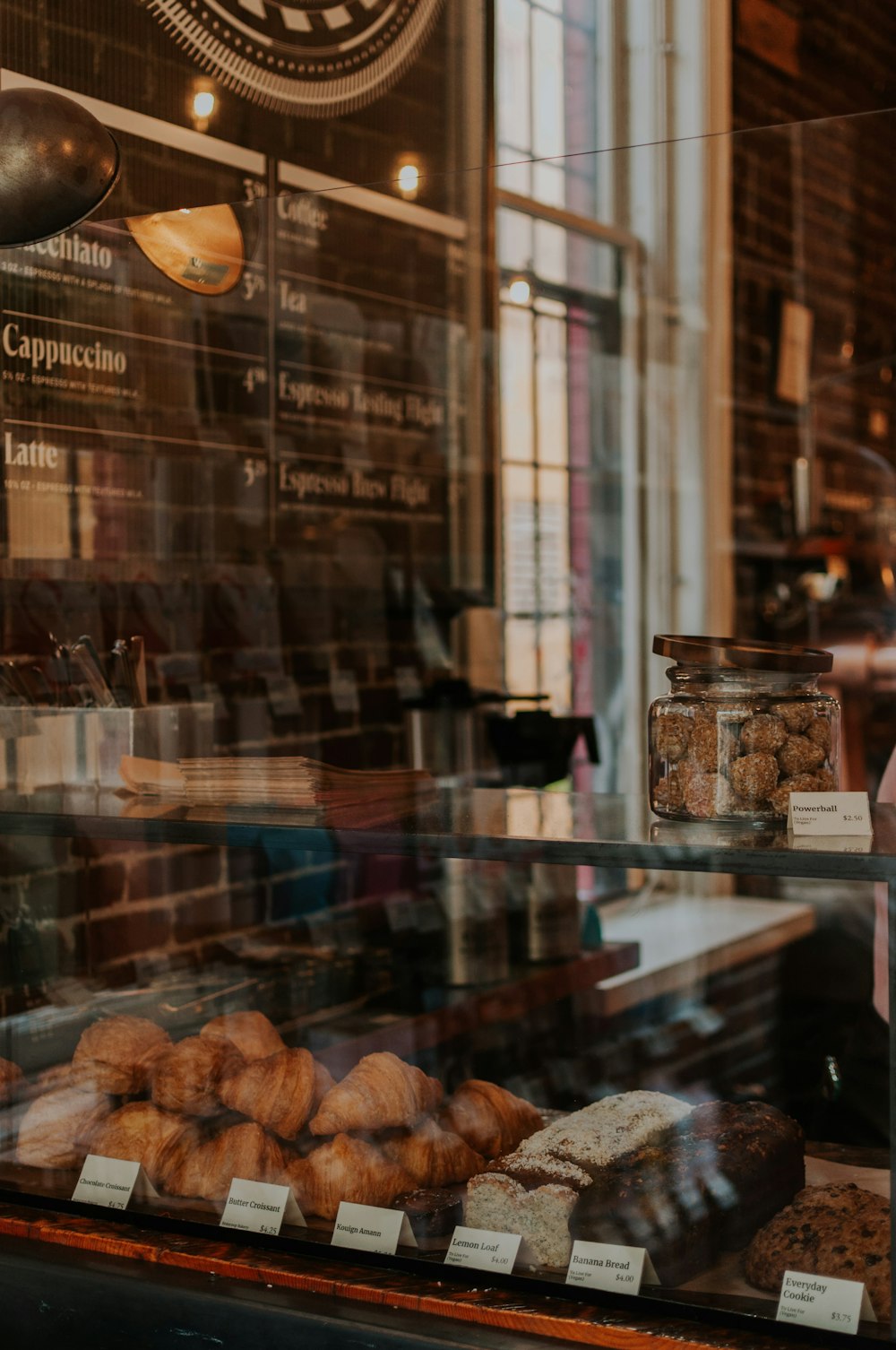 a bakery window with pastries behind glass