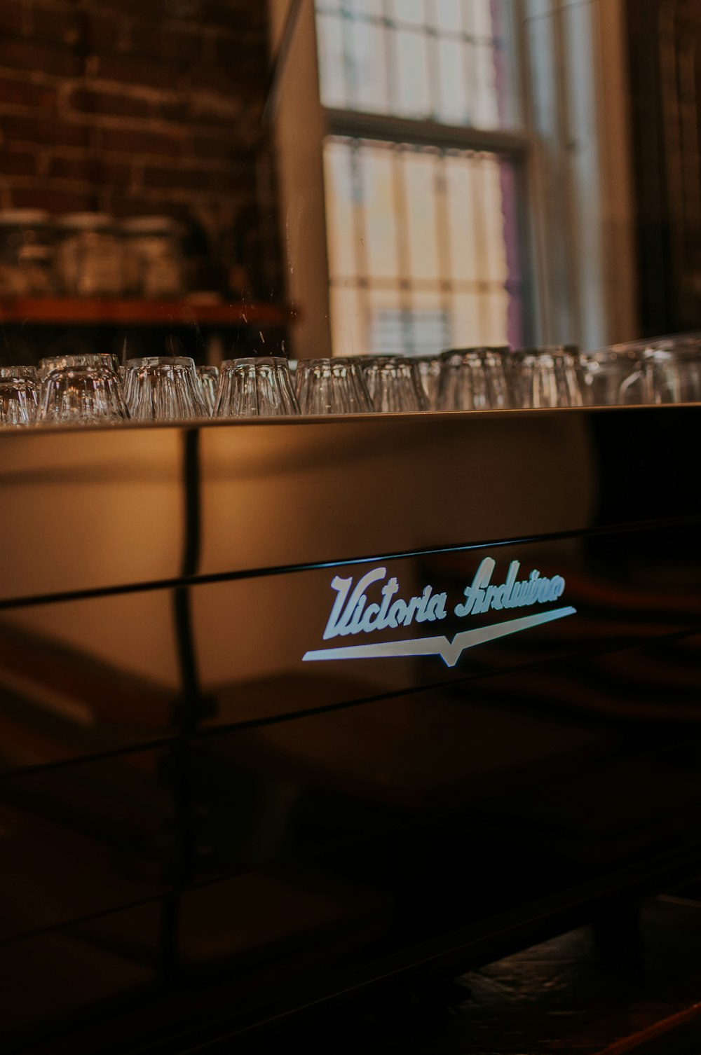 a close up of a piano with wine glasses on it