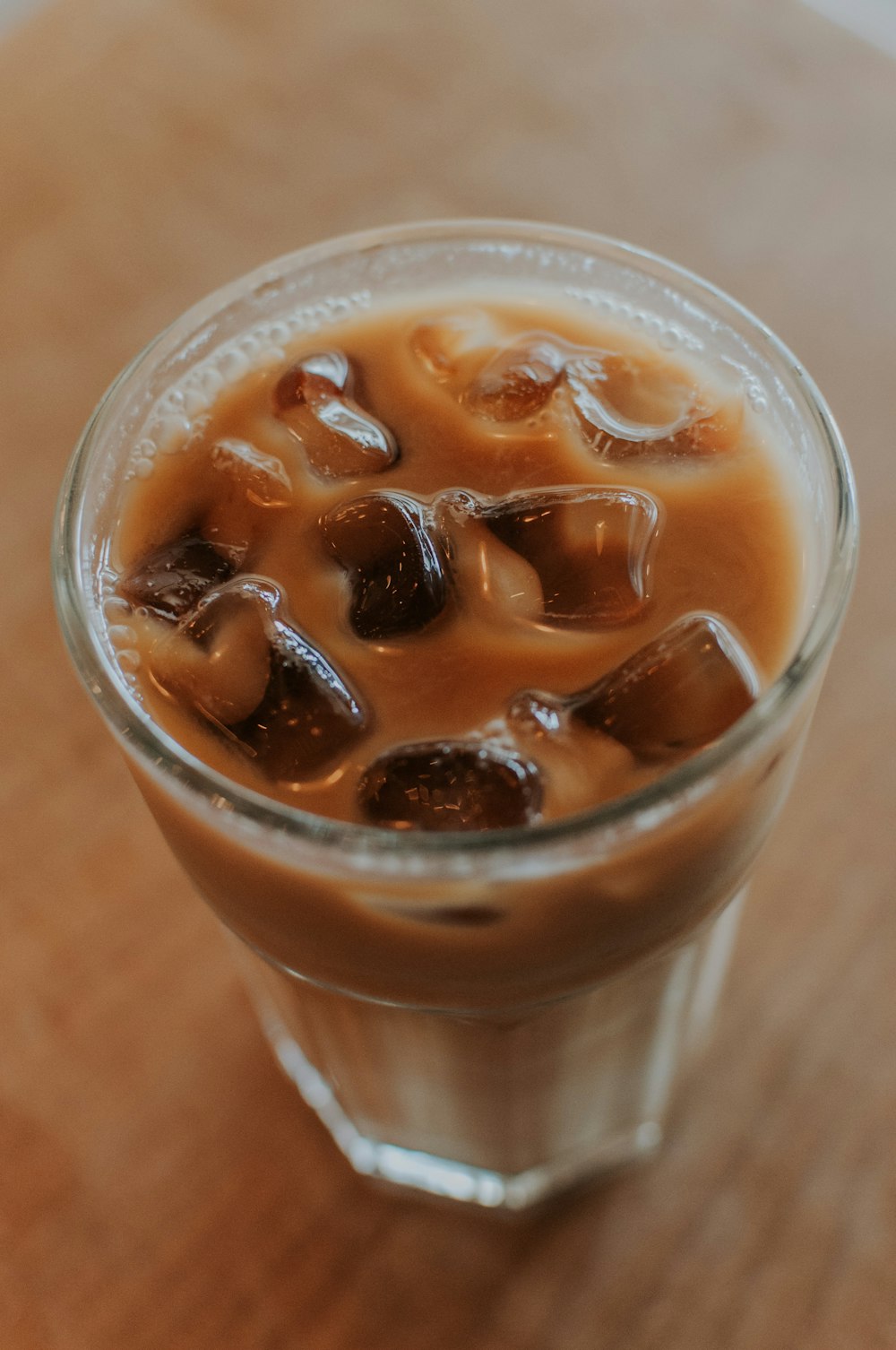 a glass of iced coffee with ice cubes