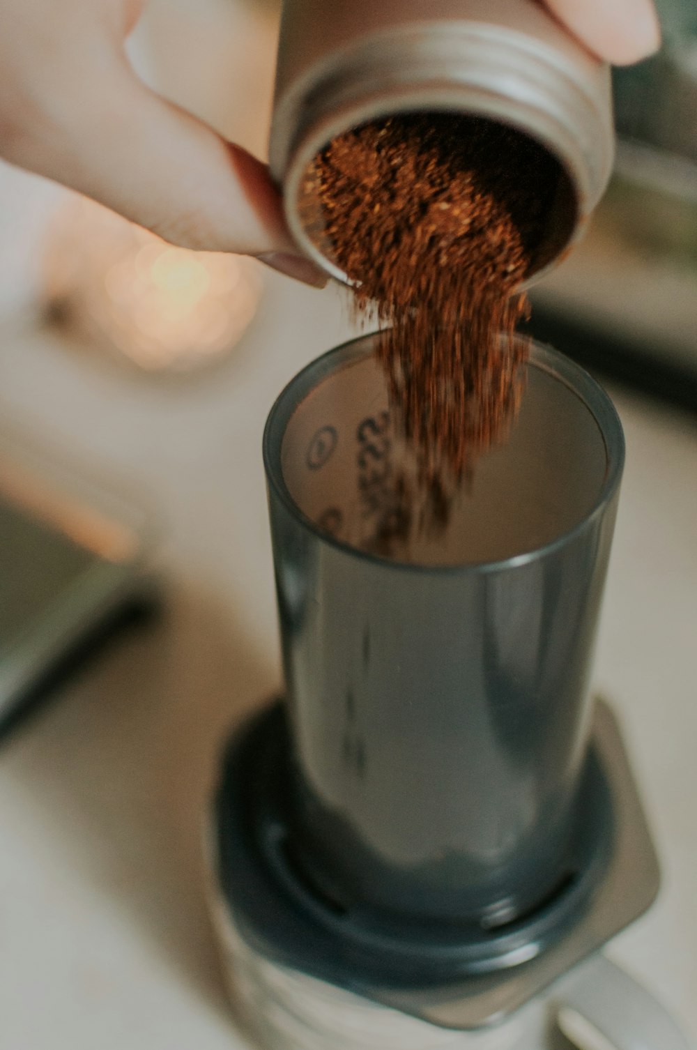 a person is pouring coffee into a cup