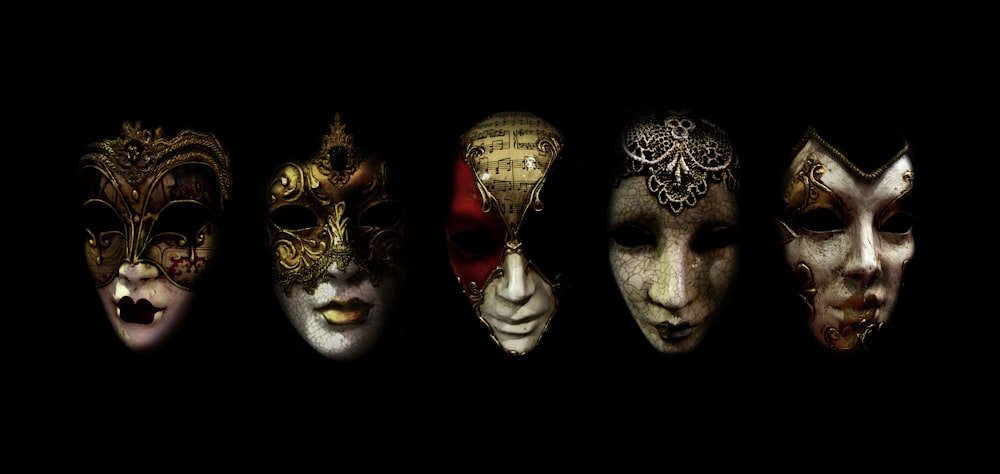 a row of different colored masks on a black background