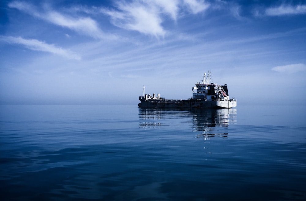 a boat floating on top of a large body of water