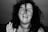 a black and white photo of a woman smiling