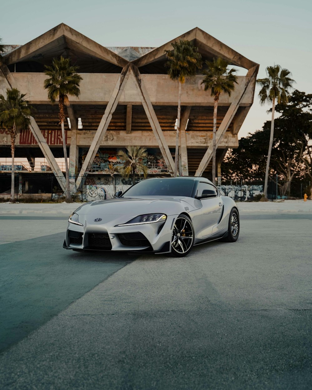 a white sports car parked in front of a building