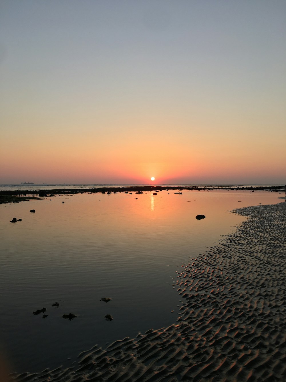 the sun is setting over a body of water