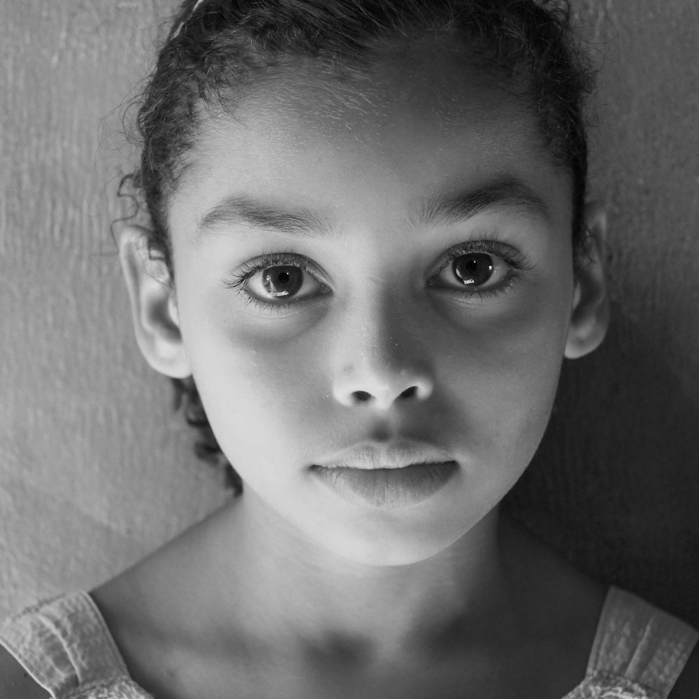 a black and white photo of a young girl